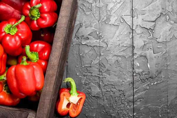 stock image Fresh red sweet pepper in the box. On black rustic background