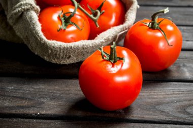 Yatakta olgun domates. Ahşap arka plan üzerinde