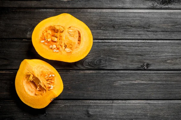 Stock image Pieces of ripe pumpkin. On wooden background