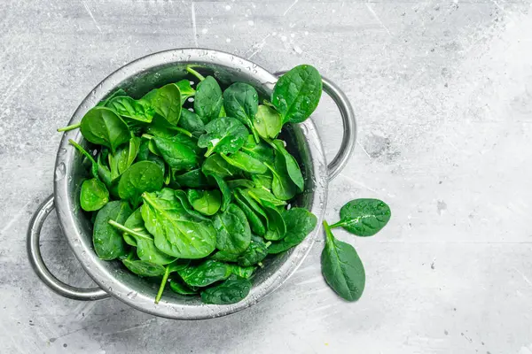 stock image Spinach in a saucepan. On white rustic background