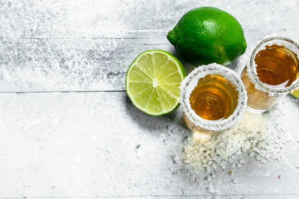 stock image Tequila with fresh lime. On white rustic background