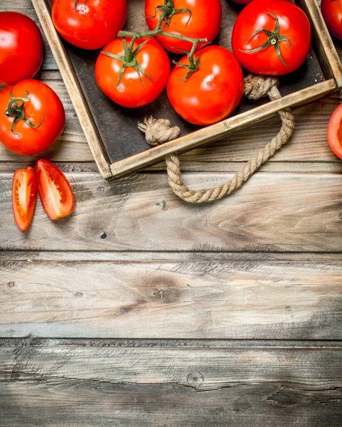 stock image Ripe tomatoes on tray. On wooden background