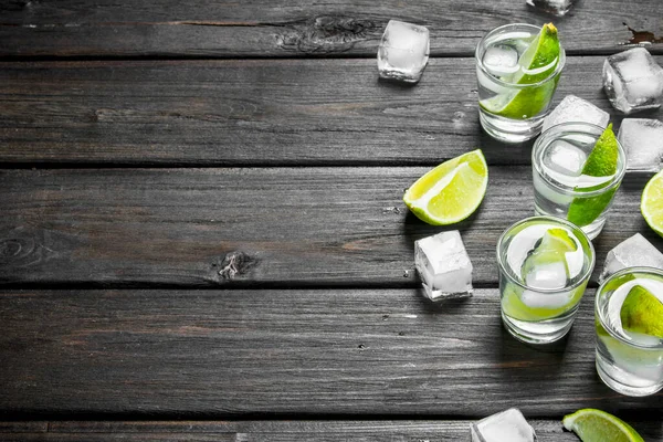 Vodka Shot Glass Lime Ice Black Wooden Background — Stock Photo, Image