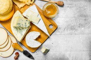 Bal ile peynir çeşitleri. Rustik bir arka plan üzerinde.