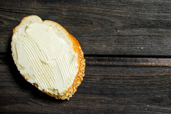 stock image Fresh bread and butter. On a Wooden background.