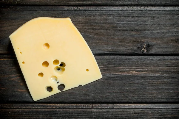 stock image Fresh piece of cheese. On a wooden background.