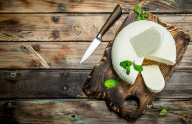 Nane ile yumuşak peynir bırakır. Ahşap bir arka plan üzerinde.