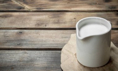 Bir bardak taze süt. Ahşap bir arka plan üzerinde.