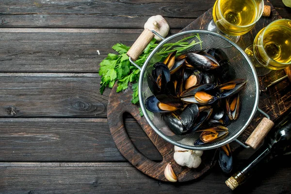 Taze deniz ürünleri deniz tarağı ile beyaz şarap. Ahşap bir arka plan üzerinde.