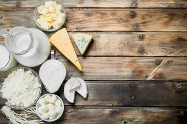 Variety of fresh dairy products. On a wooden background. clipart