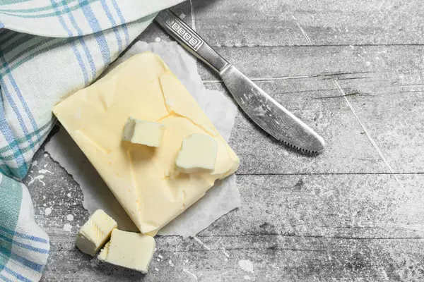 stock image Butter with a napkin. On a rustic background.