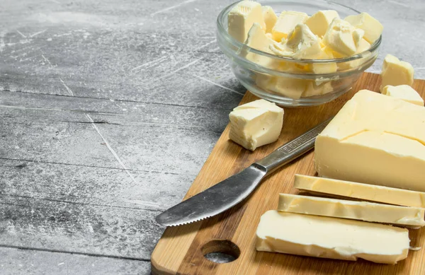 stock image Butter on a wooden Board. On a rustic background.