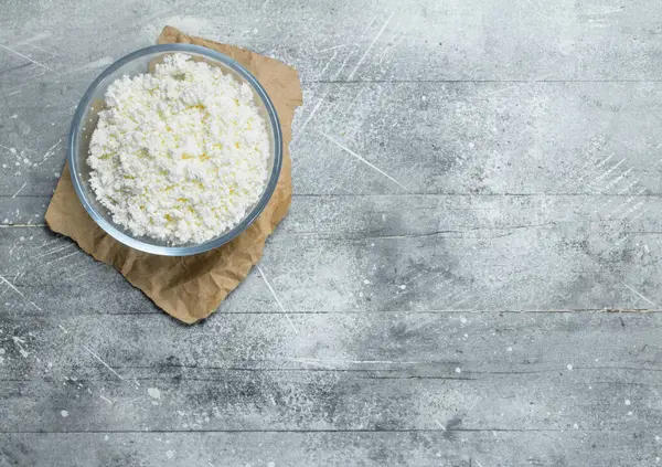 stock image Cottage cheese in bowl . On a rustic background.