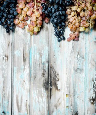 Siyah ve beyaz üzümler. Rustik bir arka plan üzerinde.