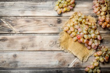 White ripe grapes. On a wooden background.