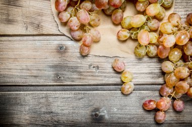 White ripe grapes. On a wooden background.