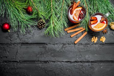 Noel baharatlar ile şarap mulled. Rustik siyah arka plan üzerine.