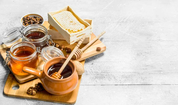 stock image Different types of honey on the Board. On a rustic background.