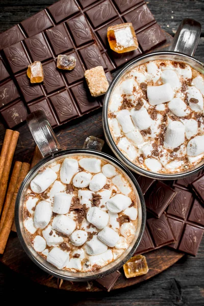 marshmallow ile bir bardak ot çikolata. Ahşap bir arka plan üzerinde.
