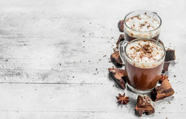 Sıcak çikolata bitter çikolata ve şekerleme parçaları ile. Rustik bir arka plan üzerinde.