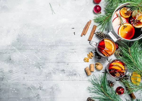 Stock image Christmas hot mulled wine with aromatic spices. On a rustic background.