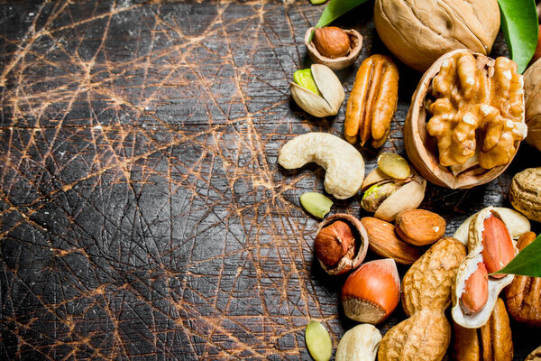 Nuts background. Different Range of natural nuts . On a wooden background.