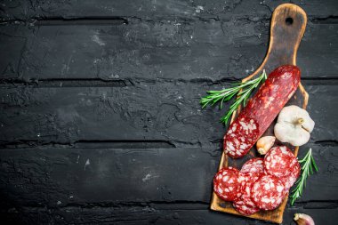 Salam sarımsak ve biberiye ile. Rustik siyah arka plan üzerine.