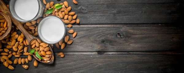 Stock image Almond milk in glasses . On a wooden background.