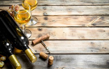 Şarap arka plan. Beyaz şarap taze üzüm dalları ile. Ahşap bir arka plan üzerinde.