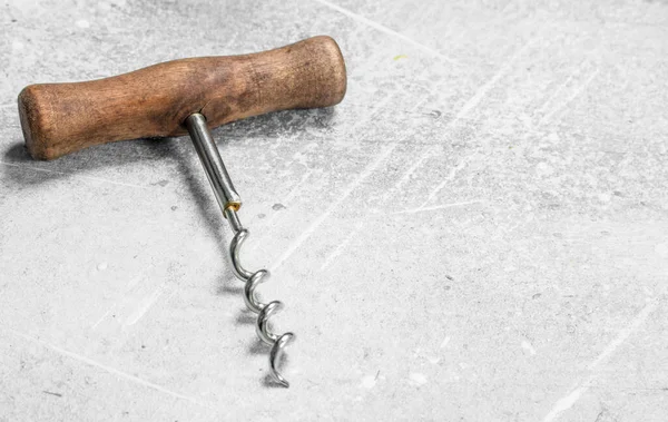 stock image Corkscrew for wine bottles. On a rustic background.