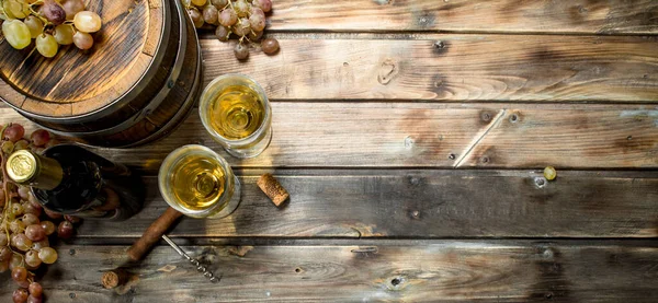 stock image Wine background. White wine in an old barrel. On a wooden background