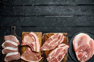 Domuz eti farklı türde. Siyah bir rustik arka planda.