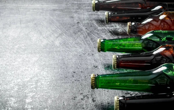 stock image Beer in glass bottles. On rustic background