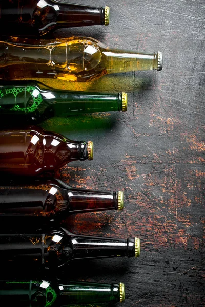 stock image Glass beer bottles. On dark rustic background