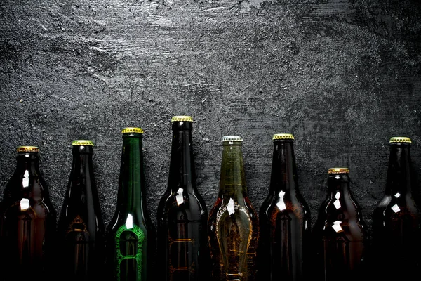 stock image Closed beer bottles. On black rustic background