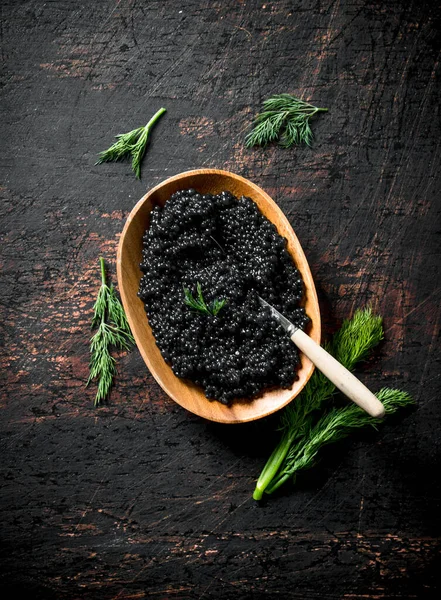 stock image Black caviar in a bowl with dill. On rustic background