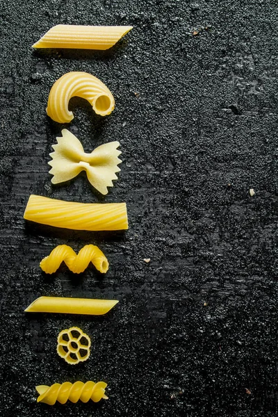 Assortment Different Types Pasta Dry Black Rustic Background — Stock Photo, Image