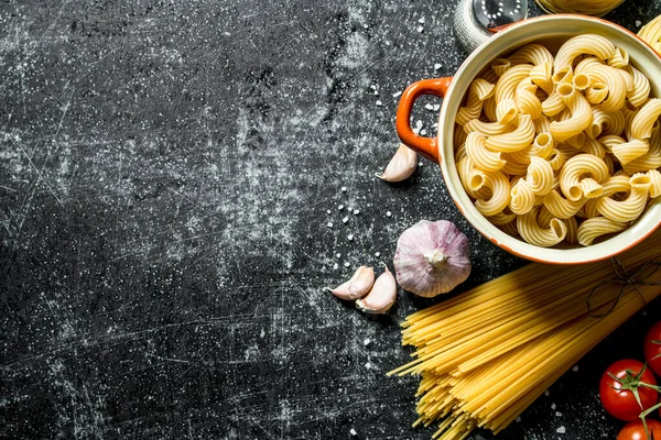 Stock image Different types of raw paste with spices, tomatoes and garlic. On black rustic background