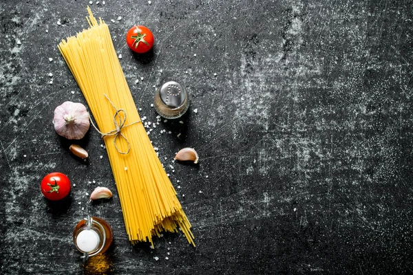 Rohe Spaghetti Mit Knoblauchzehen Und Tomaten Auf Rustikalem Hintergrund — Stockfoto