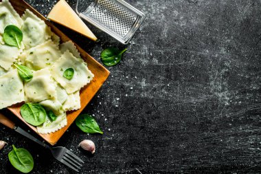 Sarımsak, peynir ve ıspanak ile Ravioli. Koyu rustik arka plan üzerinde