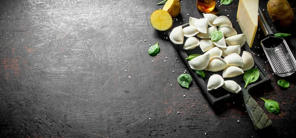 stock image Raw dumpling with potato, Parmesan and spinach. On dark rustic background