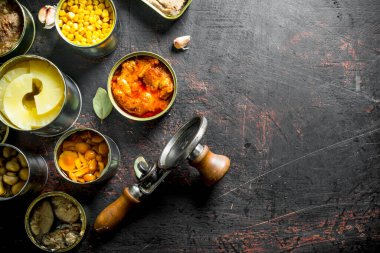 Konservelerde çeşitli konserve ler. Koyu rustik arka plan üzerinde