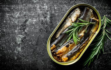 Biberiye bir ton içinde sprats. Koyu rustik arka plan üzerinde