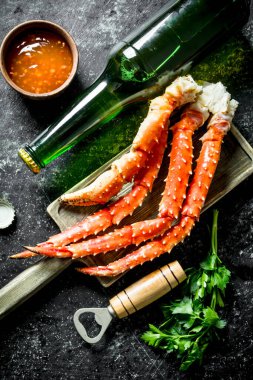 Soslu yengeç, bira ve otlar. Koyu rustik arka plan üzerinde