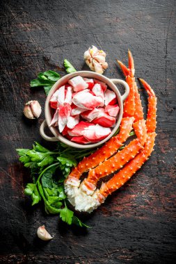 Kasede yengeç eti ve soslu taze yengeç ve sarımsak karanfil. Koyu rustik arka plan üzerinde