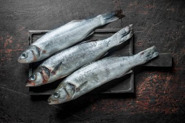 Kesme Tahtası'nda çiğ balık. Koyu rustik arka plan üzerinde