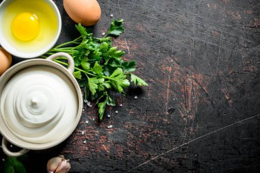 Maydanoz ve yumurta ile kasede mayonez. Koyu rustik arka plan üzerinde