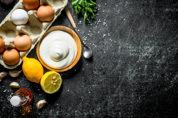 stock image Mayonnaise with eggs and lemon. On dark rustic background