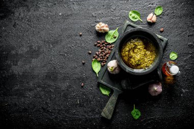 Çam fıstığı, fesleğen ve zeytinyağı ile Pesto sos. Siyah rustik arka plan üzerinde