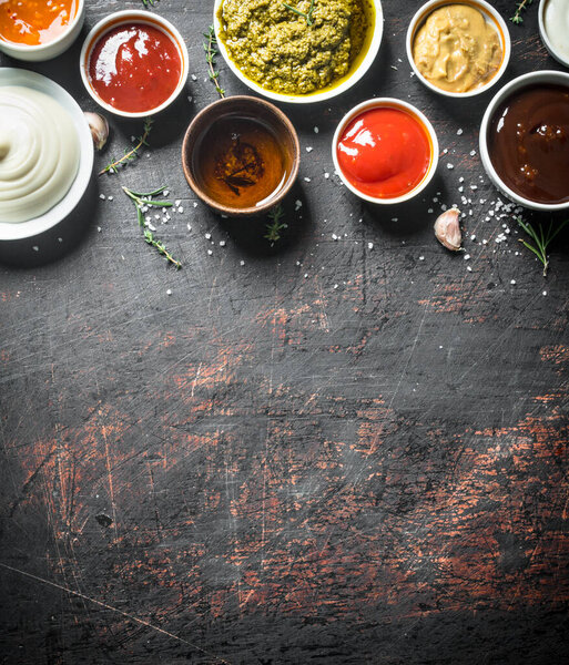 Variations of delicious sauces. On dark rustic background